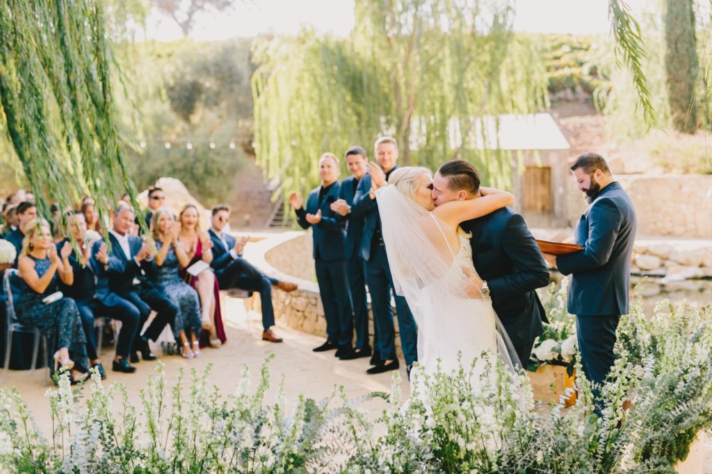 first kiss of bride at groom at a Terra Mia Fall Wedding